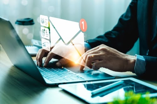Man emailing on a laptop.