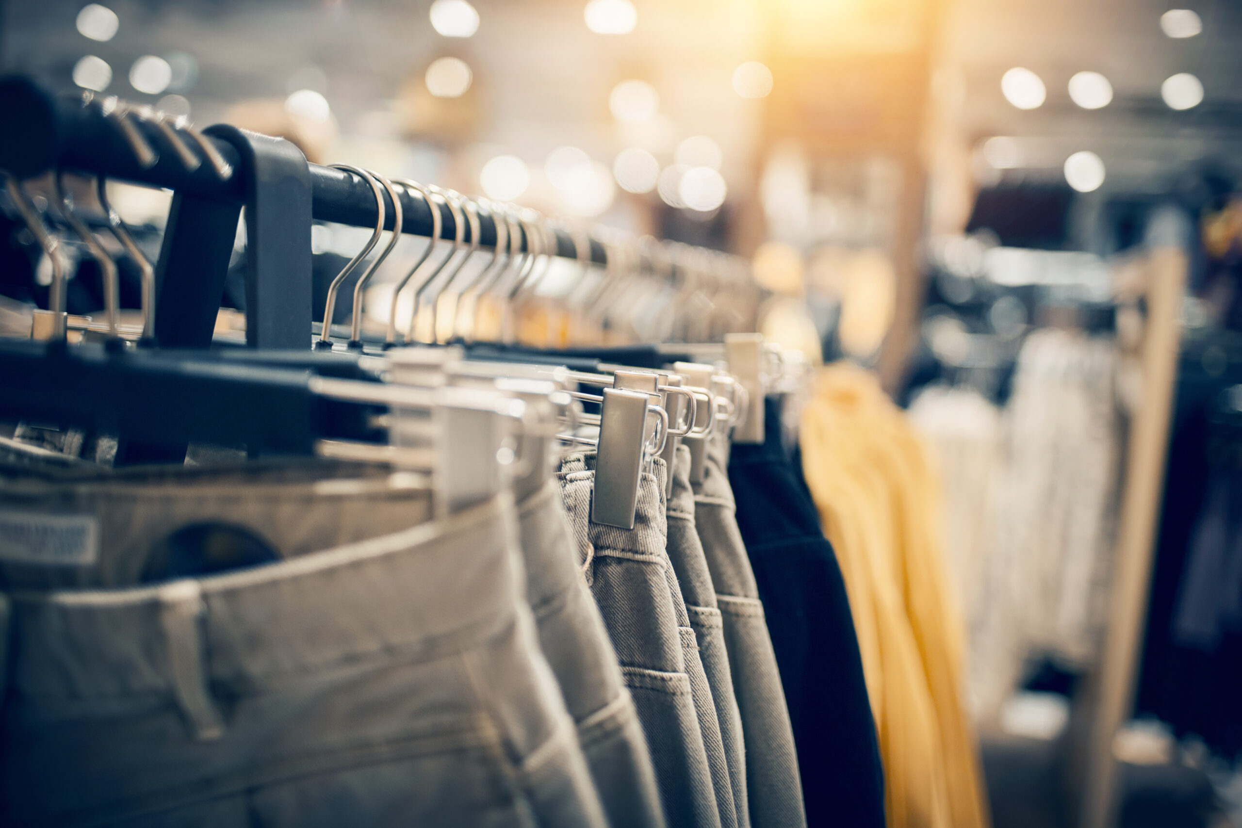 Jeans hanging on a rack.